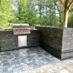 outdoor kitchen with grill and paver patio