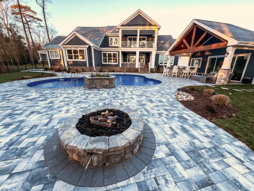 fire pit on paver patio by pool