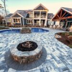 fire pit on paver patio by pool