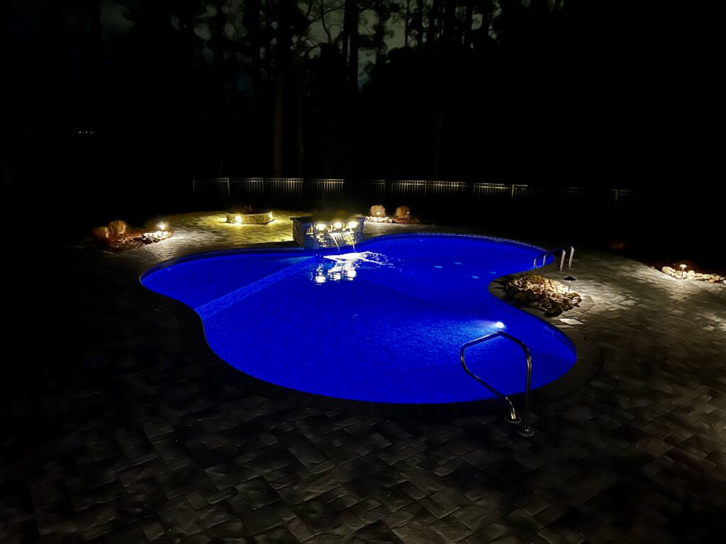 in-ground pool at night